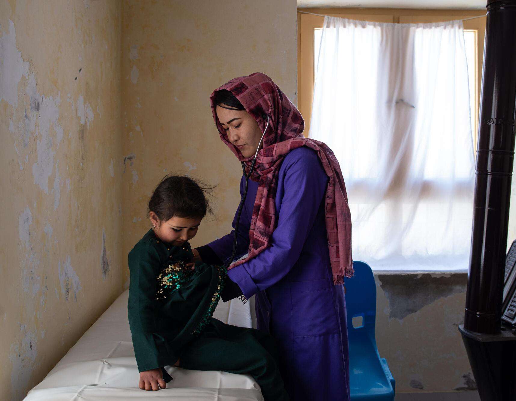 A mother and child next to the shadow of a window in Bamyan province, Afghanistan.