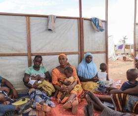 Mothers and their children in a women's club session in an IDP camp in Kongoussi, Burkina Faso