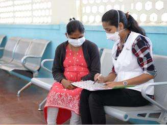 An MSF staff member in India talks to a patient who was part of the EndTB clinical trial to find better treatments for tuberculosis.