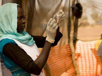 A woman prepares a polio vaccine