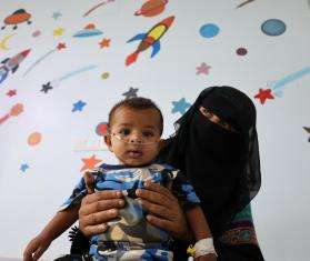 Karima holds her 6-month-old son Ahmed, who is receiving treatment at Al-Qanawis Mother and Child Hospital in Al-Hudaydah governorate, Yemen.