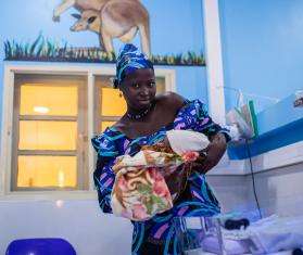 A Nigerian woman holds her newborn baby at Jahun Hospital.