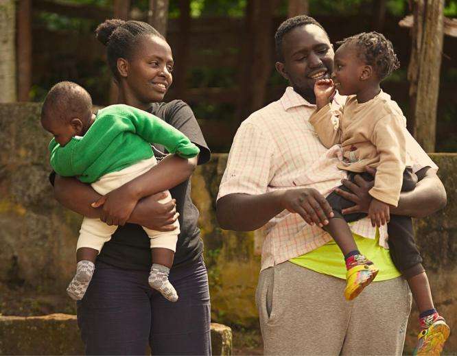 Michael Karongo with his wife Mary Wairimu—his greatest supporter in his recovery journey—and their children in Kenya.