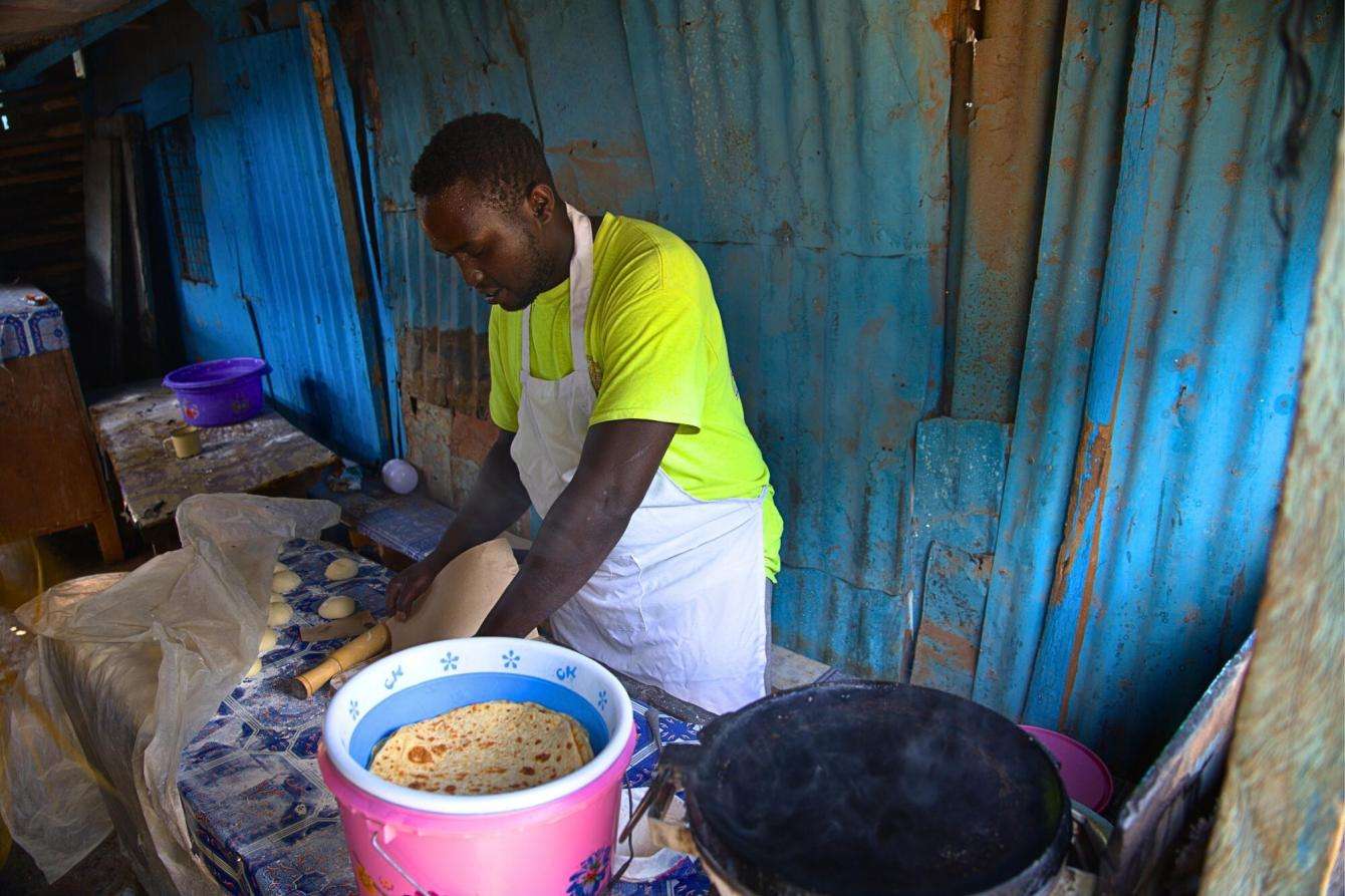 Michael Karongo at his food kiosk. Michael has been in recovery for five years and has reintegrated into his community, and now owns his business and goes to school.