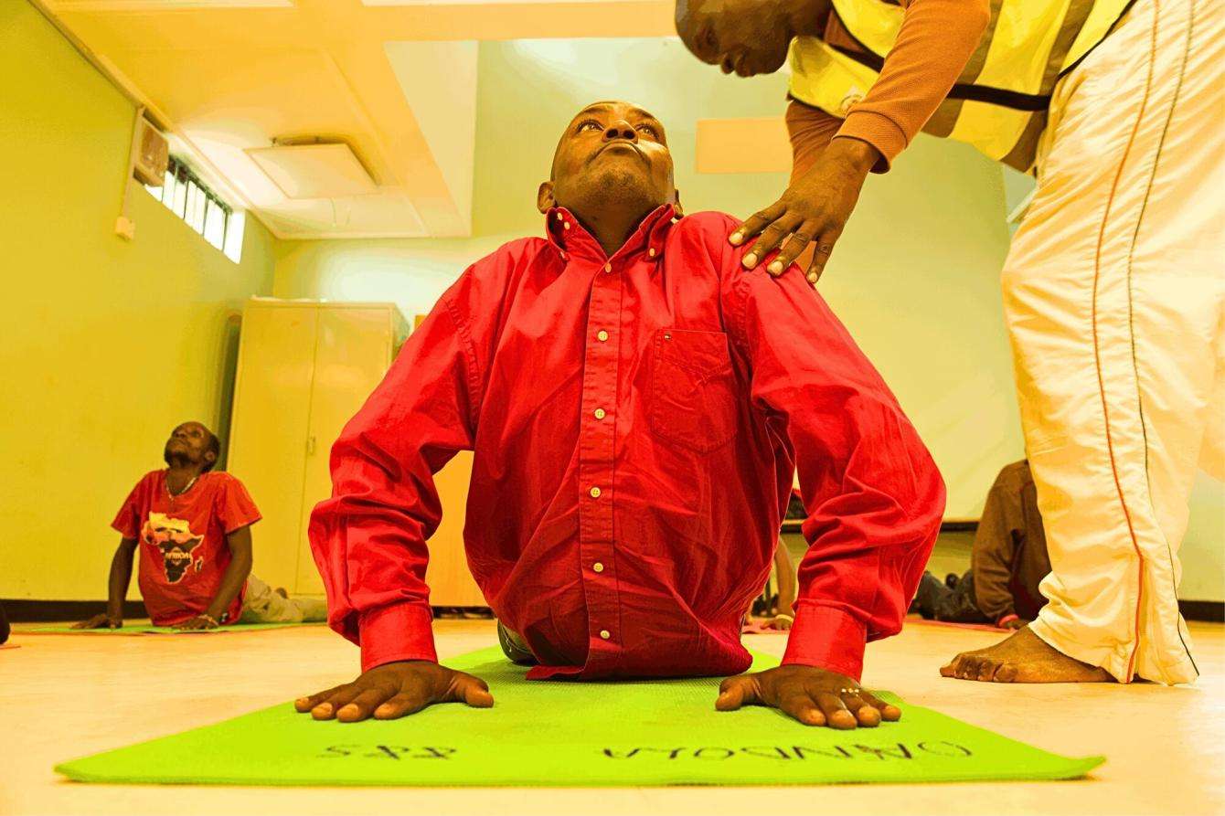 A patient is instructed during  a Yoga Session in Karuri MAT clinic, Kiambu Kenya. 