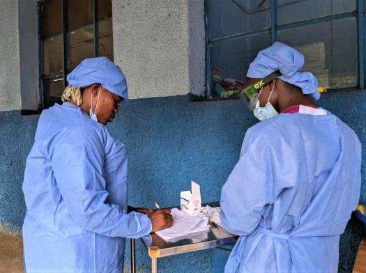 Two health workers talk at the MSF-supported Budjala general hospital in DRC.