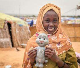 A girl in the Adre camp in Chad holds a cat toy she took with her from Sudan. 