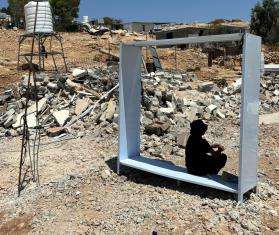 A Palestinian teenager finds shelter from the sun after his home was demolished without warning in Umm al Kheir, Masafer Yatta, West Bank.