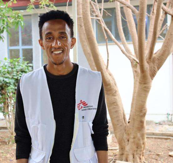 MSF health promotion officer Elias Addis stands in front of Abiy Adi Hospital in Ethiopia.