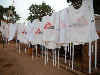 White vests with MSF logo hanging on a clothesline