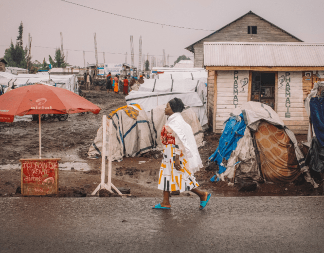 Francine, 24, from Kiwanja in Rutshuru territory, walks through the Kanyaruchinya site for displaced people where she lives, north of the city of Goma, North Kivu, Democratic Republic of Congo, 2 January 2024.