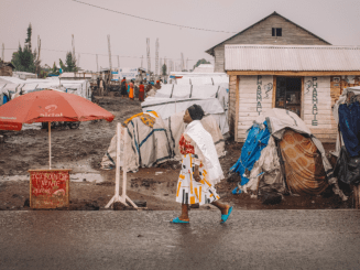 Francine, 24, from Kiwanja in Rutshuru territory, walks through the Kanyaruchinya site for displaced people where she lives, north of the city of Goma, North Kivu, Democratic Republic of Congo, 2 January 2024.