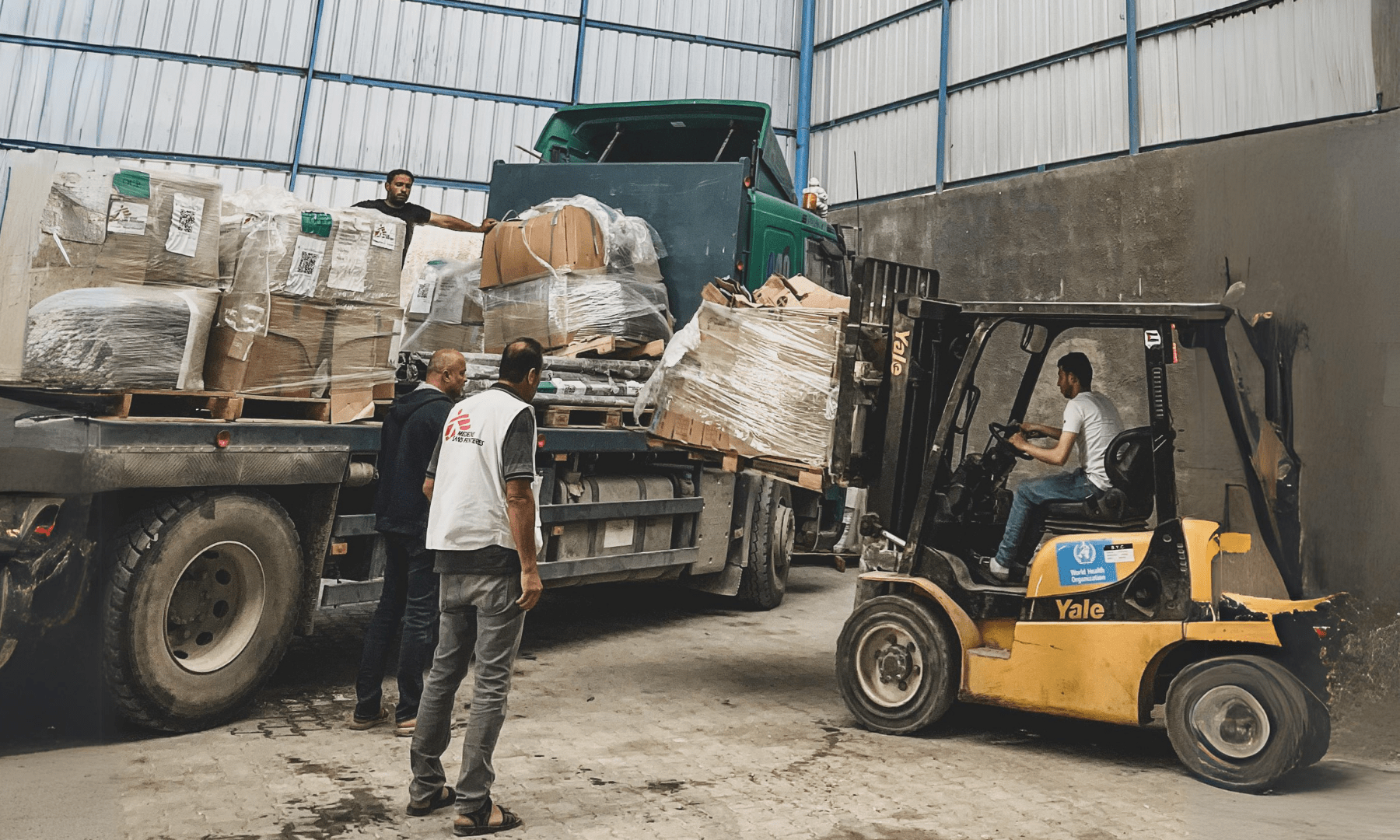 MSF staff with medical supplies in a warehouse in Gaza.